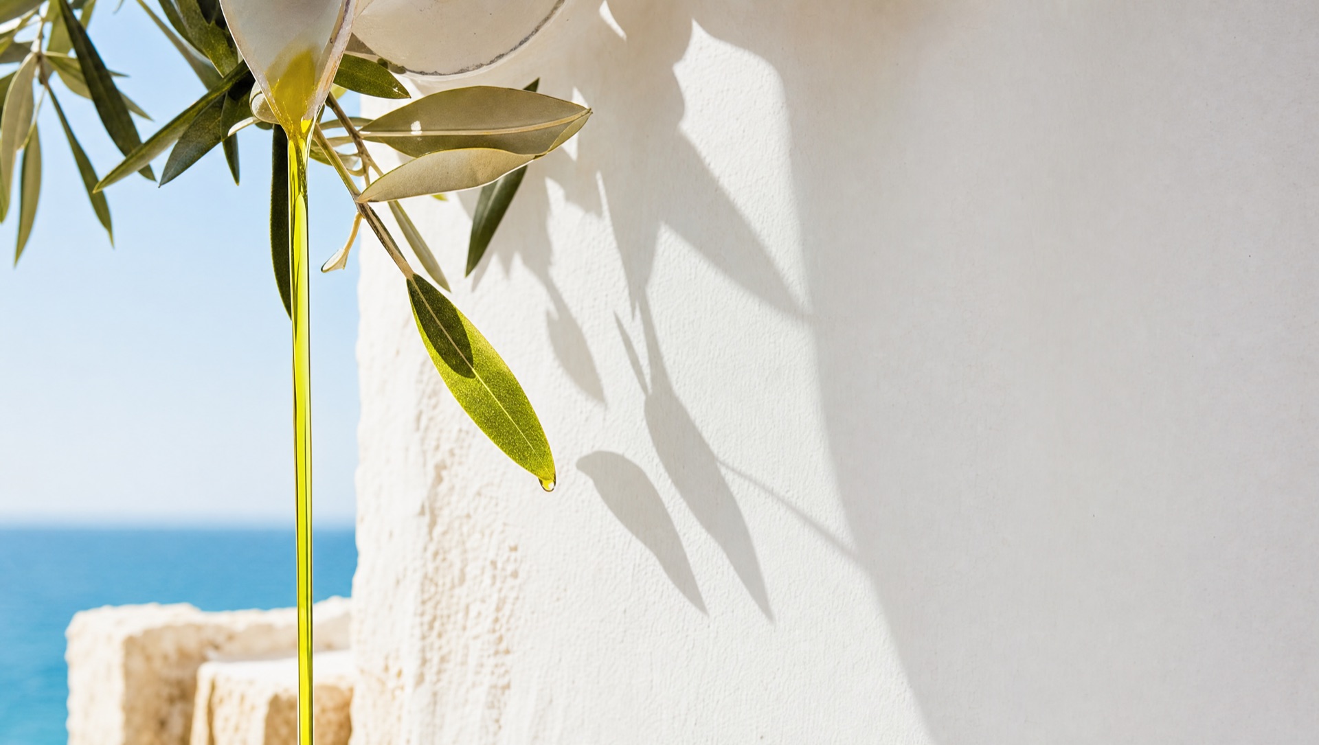Green gold olive oil pouring in bright sunlight